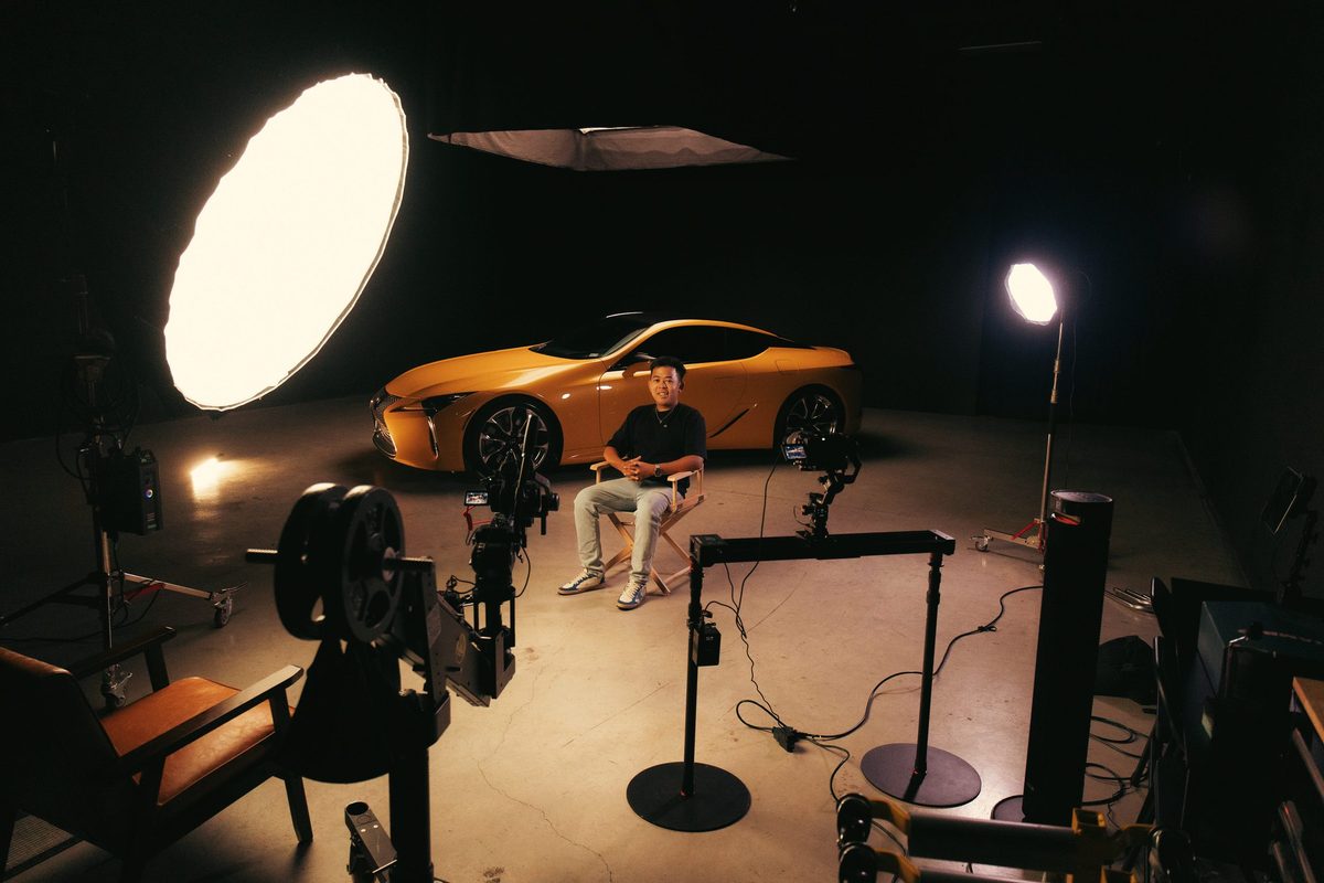 Wide view of the set with lights, stands and the interview chair beside the LC 500